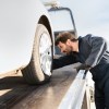 A tow truck driverloading a car