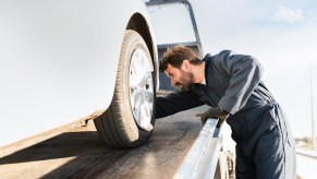 A tow truck driverloading a car