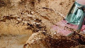 A truck splashing through mud