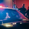 Two police officers arresting suspect at night