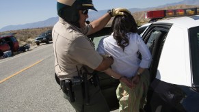 A police officer arresting a woman