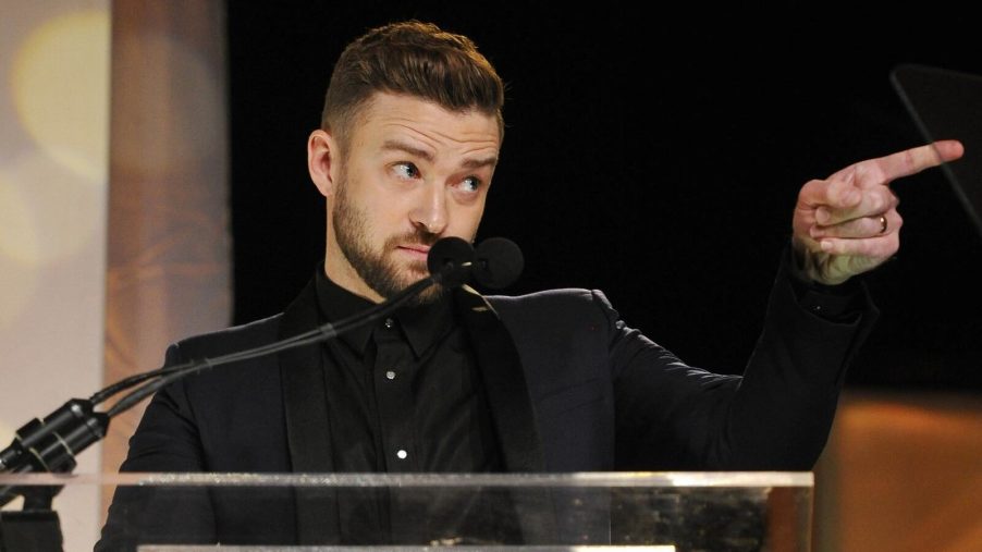 Justin Timberlake on stage pointing his finger with eyebrows raised