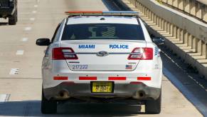 Miami Florida police cruiser driving on highway in direct rear view