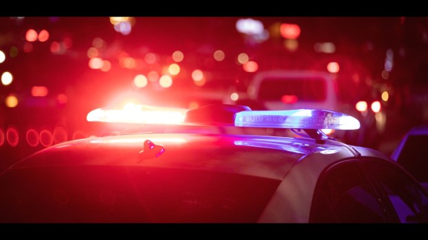 Police cruiser roof lights on at night in close view