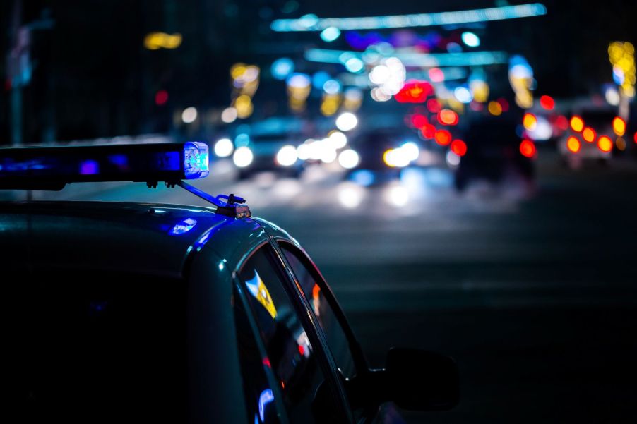 A police car driving at night