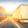 A blurred rear view of semi-truck driving on a highway