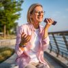 An elderly woman talking on speaker phone