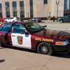 A Minnesota State Trooper cruiser parked at a curb