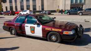 A Minnesota State Trooper cruiser parked at a curb