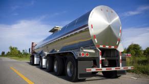 A silver tanker truck in rear view